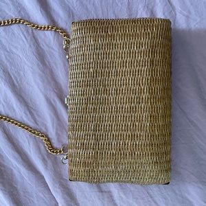 Woven purse with gold chain strap.